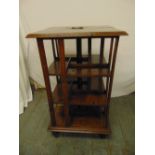 An oak revolving Canterbury bookcase possibly made from wood from the Flagship at the Battle of