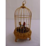 An automaton of singing birds in a gilt metal cage