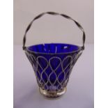 A Victorian silver wirework sugar bowl, pierced sides, swing handle, detachable blue glass liner