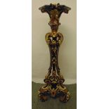 A ceramic plant stand, profusely decorated with stylised leaves and scrolls on three scroll