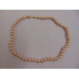 A single strand of freshwater pearls with 9ct gold clasp