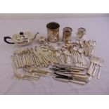 A quantity of silver plate to include a teapot, wine bottle coasters and flatware
