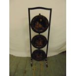 An ebonised Chinoiserie three tier plate stand