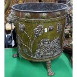 An Antique brass log bin with embossed lion decora