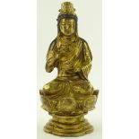 A Chinese gilt bronze seated Buddha on lotus flowe