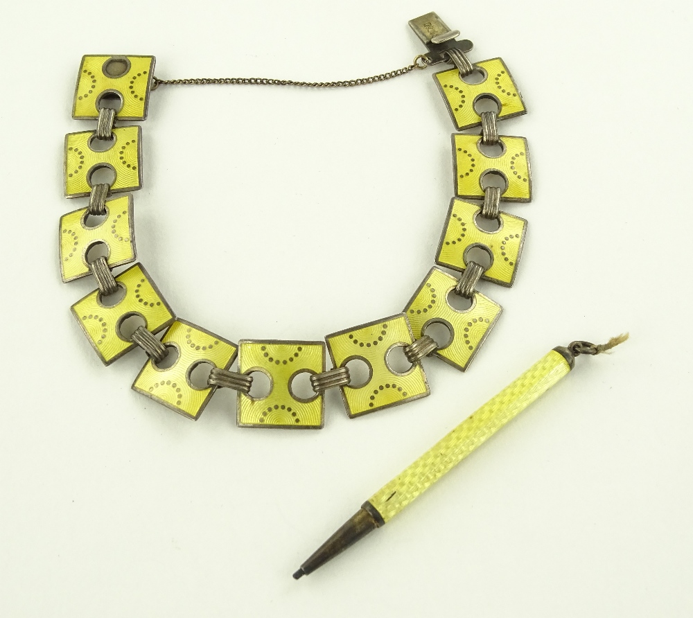 A silver and yellow enamel bracelet and an enamell