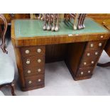 An Art Deco oak kneehole writing desk, with a tool