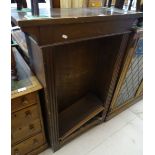 A 1920s narrow oak open bookcase with adjustable s
