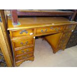 A reproduction yewwood twin pedestal writing desk,
