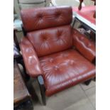 A red leather upholstered armchair.