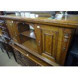An Antique oak low sideboard with open shelf and p