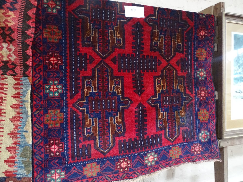 An Antique red ground Balochi rug, 140cm x 88cm.
