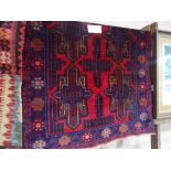 An Antique red ground Balochi rug, 140cm x 88cm.