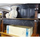 An Antique carved and panelled oak settle, width 3