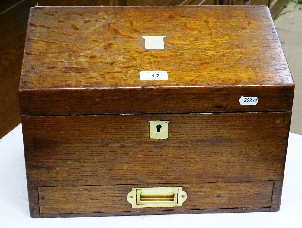 An oak desk top stationery box with drawer under.