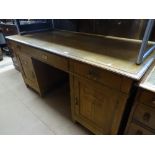An Art Nouveau oak twin pedestal writing desk with