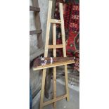 A modern pine artist's easel and a folding easel.