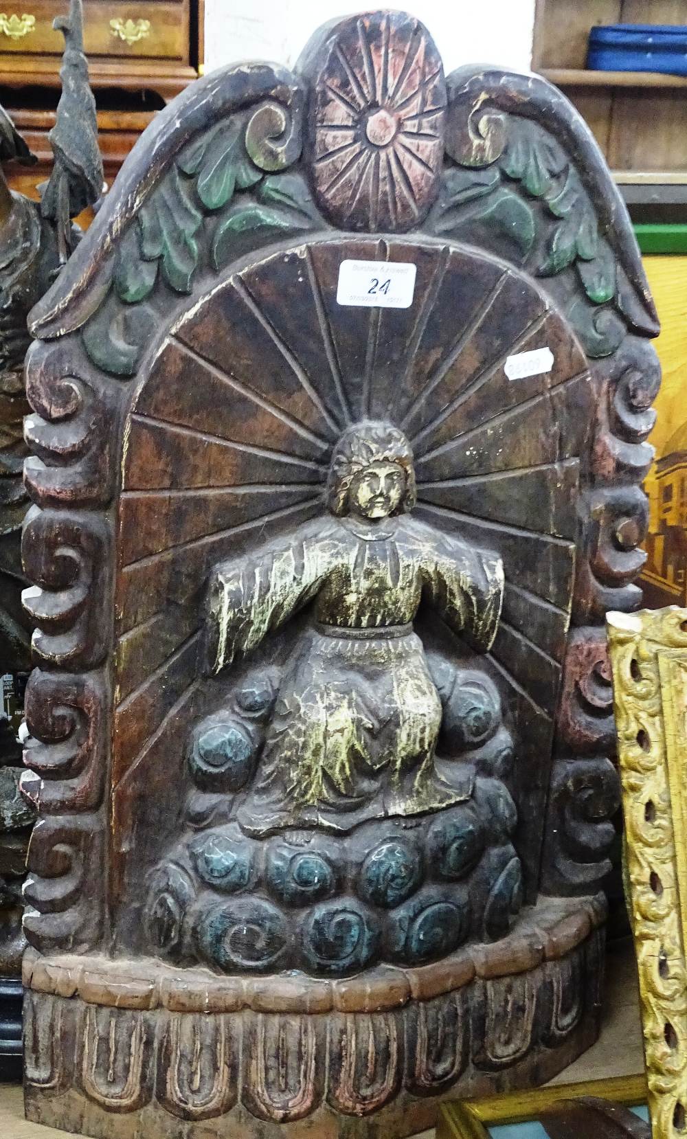 A painted, embossed shrine figure.