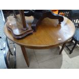 A 20th century teak circular pull-out dining table
