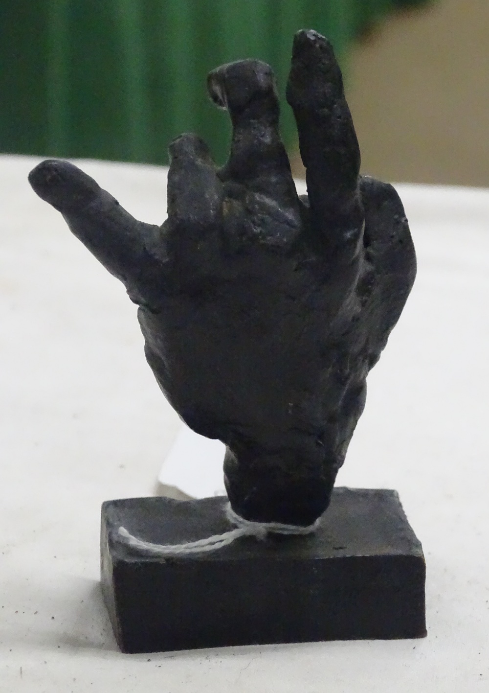 A small bronze sculpture of a hand. - Image 2 of 2