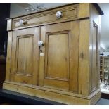 An Antique pine cabinet with single drawer and cup