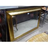 A modern gilt framed wall mirror, length 3'2".