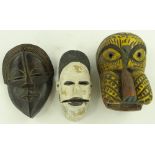 3 carved and painted wood tribal masks.