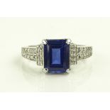 A 14ct white gold square-cut sapphire set ring wit