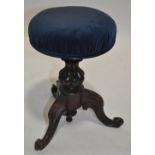 A Victorian carved rosewood revolving piano stool.