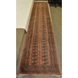 A Persian pink ground handmade wool runner.