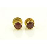A pair of unmarked gold garnet set earstuds, 6mm a