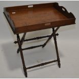 A Victorian oak butler's tray with shaped gallery