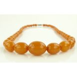 A string of butterscotch amber beads, largest bead
