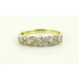 An 18ct gold diamond set half eternity ring, size