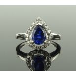 A pear-cut tanzanite and diamond cluster ring, set