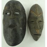 2 carved wood tribal masks.