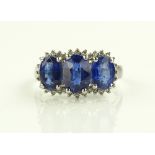 A 9ct gold sapphire and diamond triple cluster rin