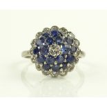 A dome shaped sapphire and diamond cluster ring, u