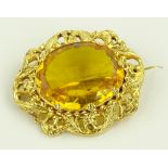An unmarked gold yellow stone set brooch, ornate p