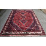 A large Persian design red ground geometric patter