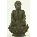 A Chinese patinated bronze seated Buddha, probably