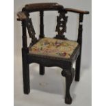 A Victorian carved oak corner chair.