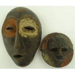 2 African carved wood tribal masks.