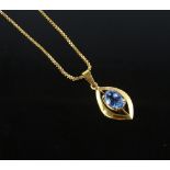 An unmarked gold leaf shaped pendant set with oval