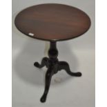 An Antique circular mahogany tea table on tripod b