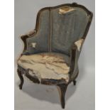 A French carved beech framed fireside armchair, wi