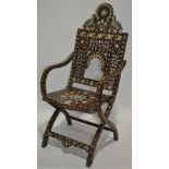 An ornate 19th century Moorish folding armchair, e