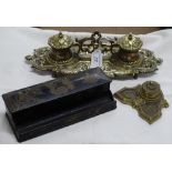 An embossed cast brass desk stand with 2 inkwells