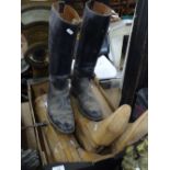 A pair of wooden riding boot trees, a single boot