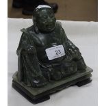 A carved green stone Buddha.